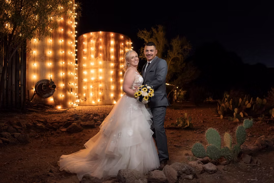 Couple at night beside the marquee light wall