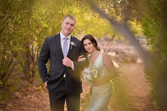 Newlyweds on the garden path in golden light