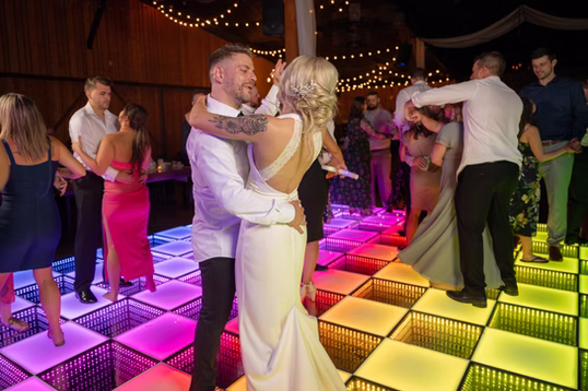 Dancing on the LED dance floor under string lights