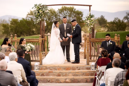Saying vows at the arch at dusk
