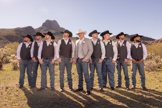 Groomsmen in cowboy hats in the desert